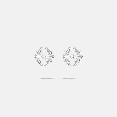 A brass silver colored pair of logo stud fantasy earrings with floral inspired spikes, product viewed from the front
