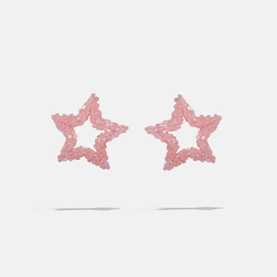 Star-shaped beaded earrings with pink glitter on a light gray background