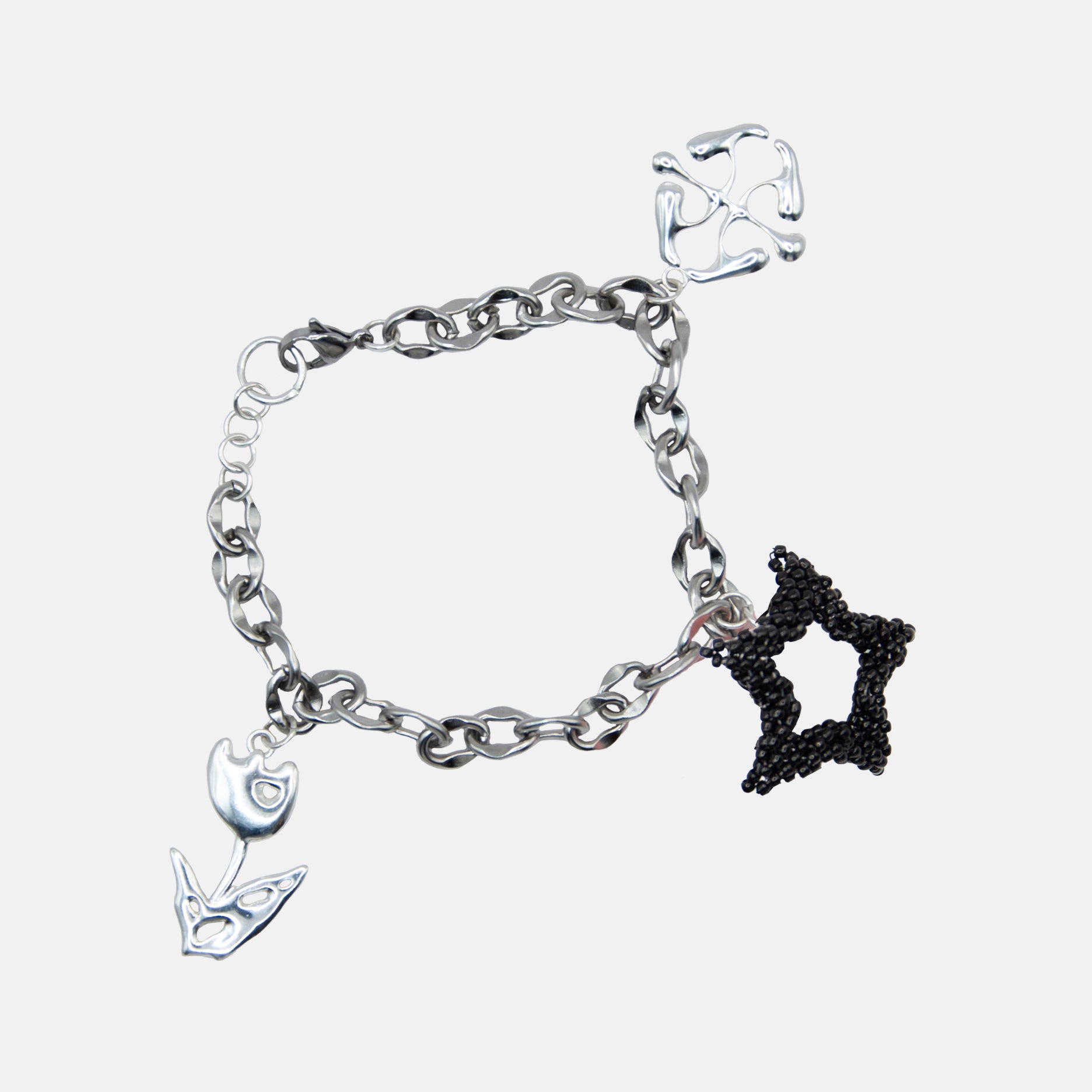 Silver bracelet with black beaded star charm on a white background