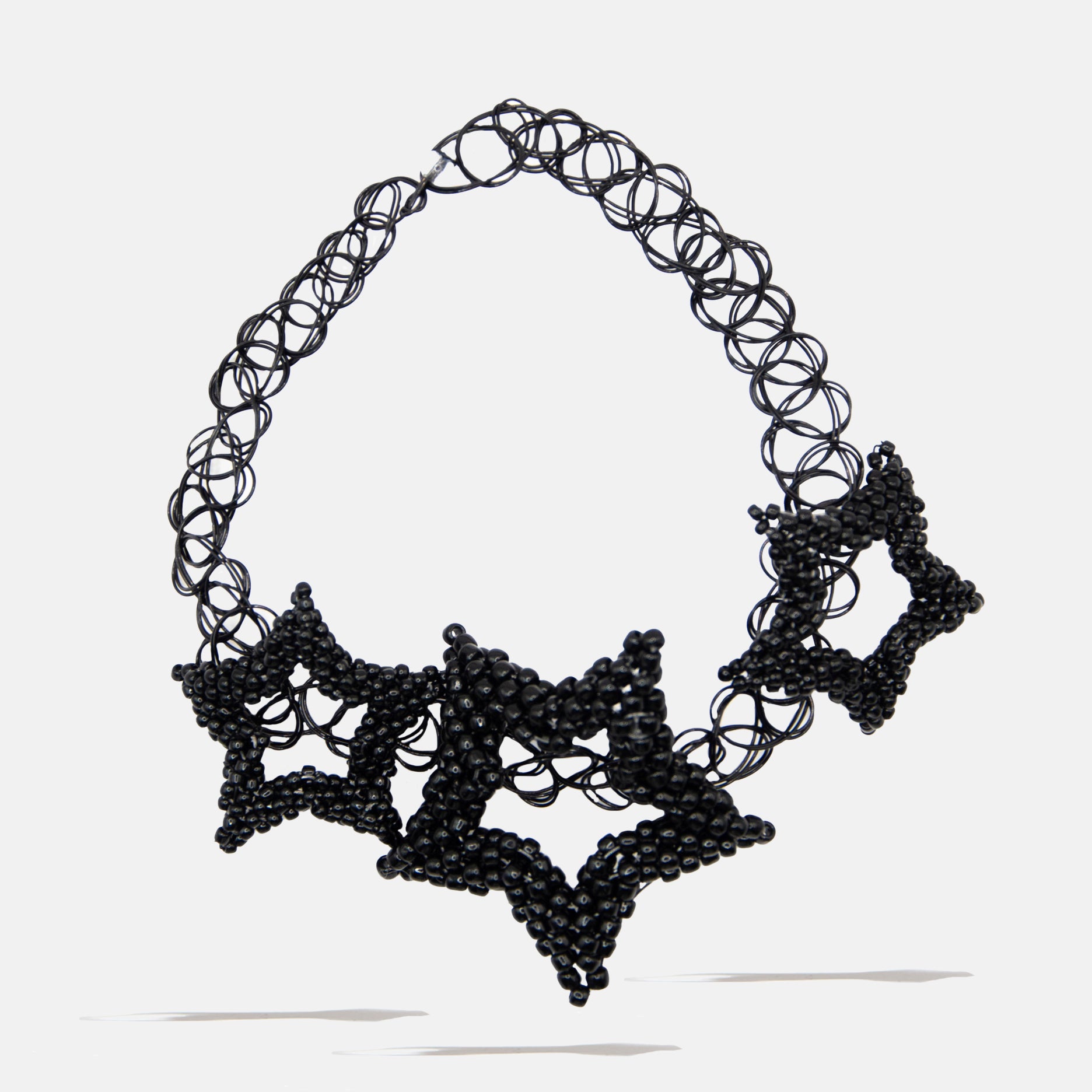 Black star beaded tatoo necklace on a white background