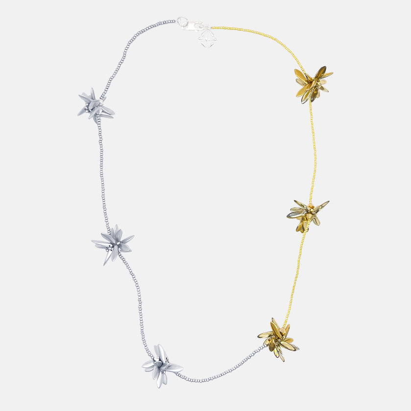 Silver and gold necklace with floral beaded pendants on a white background