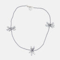 Silver necklace with floral pendants on a white background