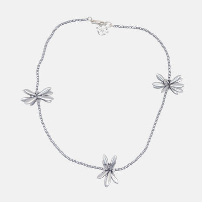 Silver necklace with floral pendants on a white background