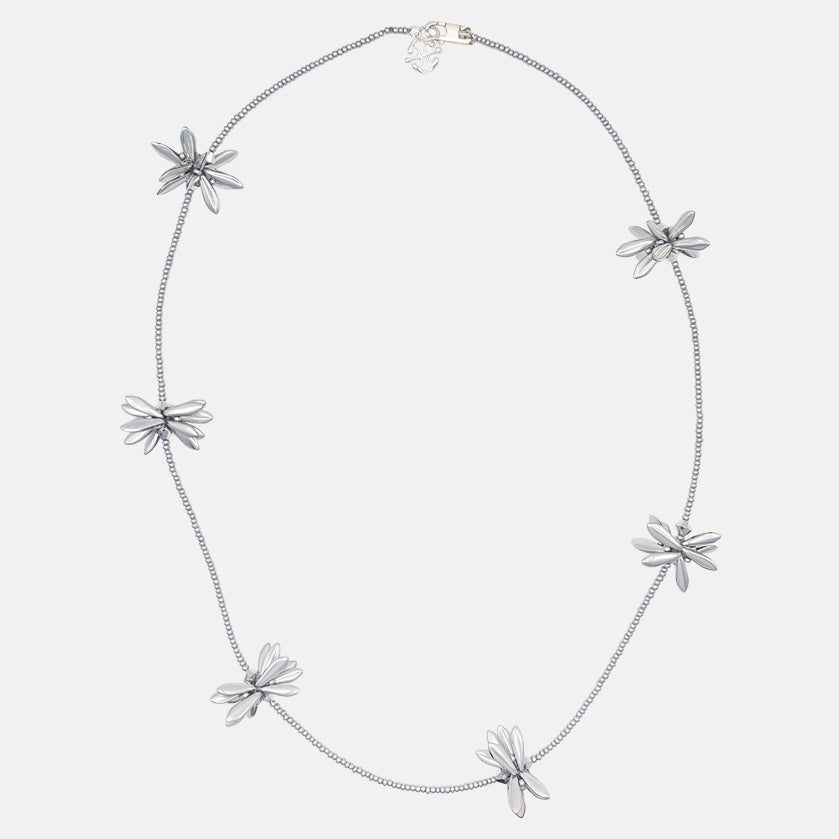 Silver necklace with floral beaded pendants on a white background