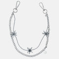 Silver pants chain with floral pendants on a white background