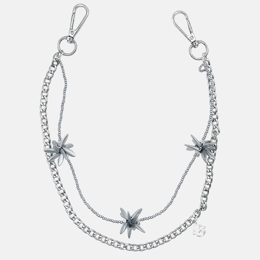 Silver pants chain with floral pendants on a white background