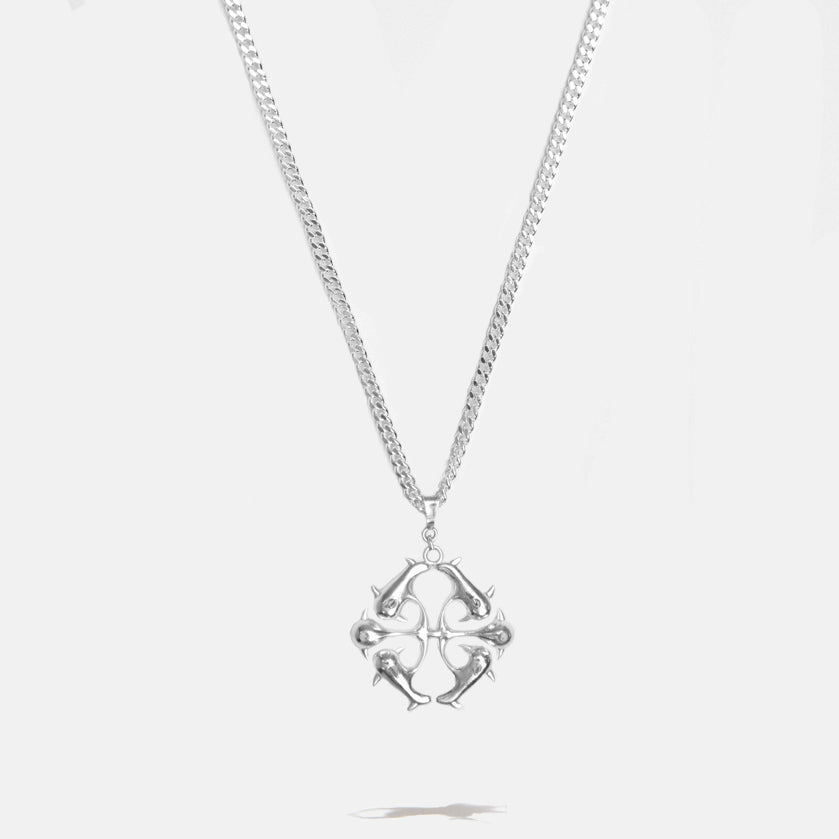 Silver logo necklace with detailed spikes pendant on a light gray background