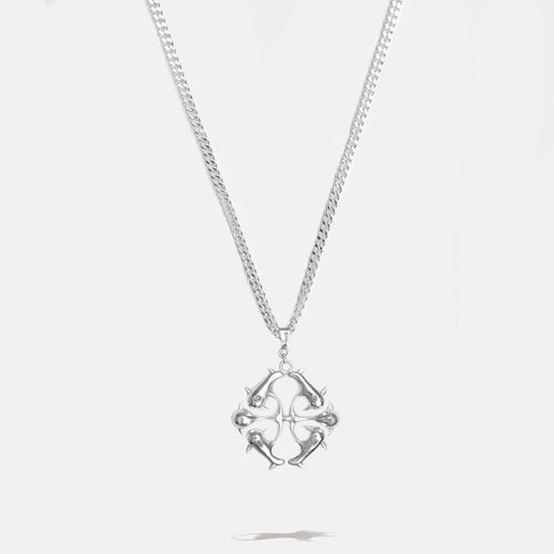 Silver logo necklace with detailed spikes pendant on a light gray background