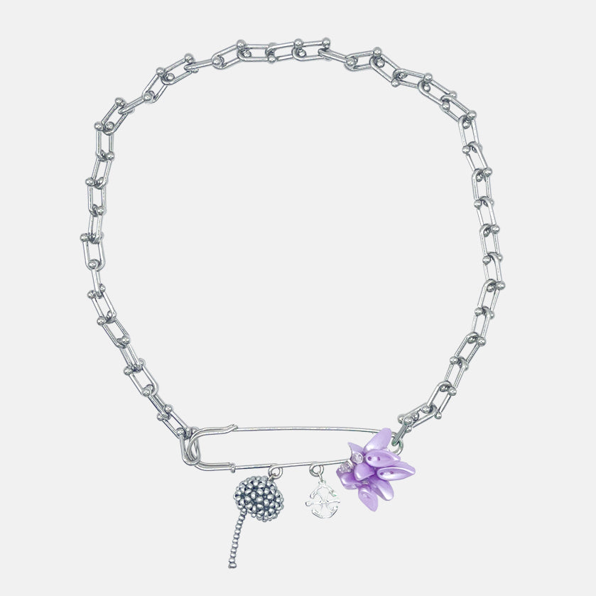 stainless steel chain necklace with multi charms brooch and beaded mushroom in silver beads and an acid purple beaded flower on a white background