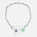 Silver chain necklace with multi floral charms in acid green on a brooch on a white background