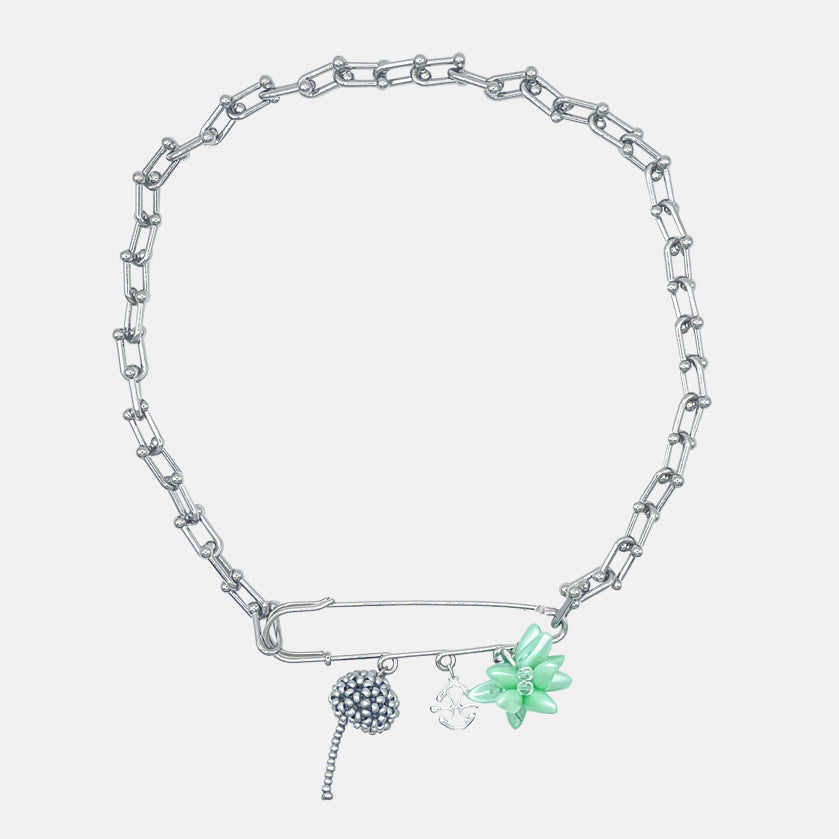 Silver chain necklace with multi floral charms in acid green on a brooch on a white background