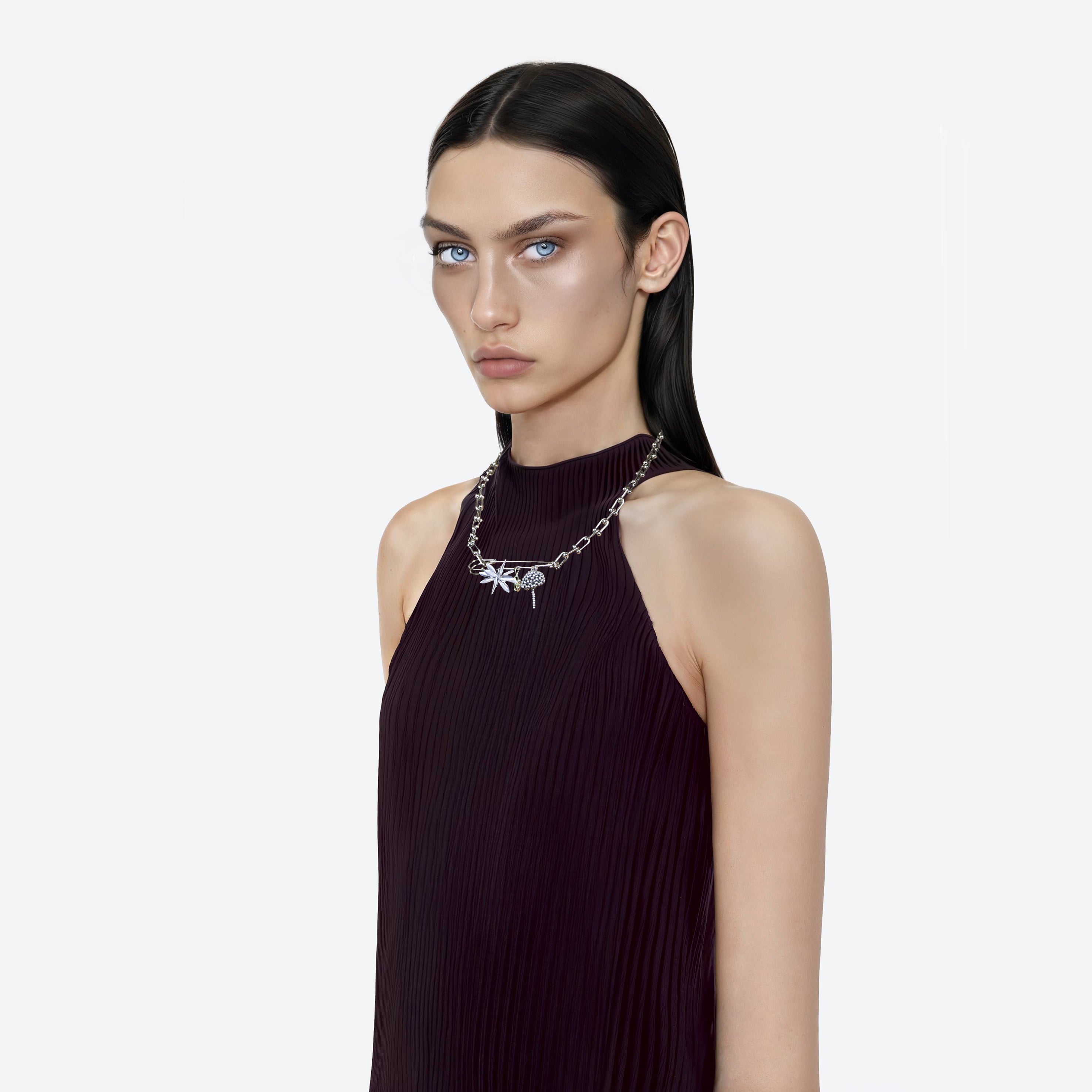 Model wearing a silver multi charms beaded necklace on a white background