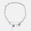 Silver necklace with beaded charms on a light gray background
