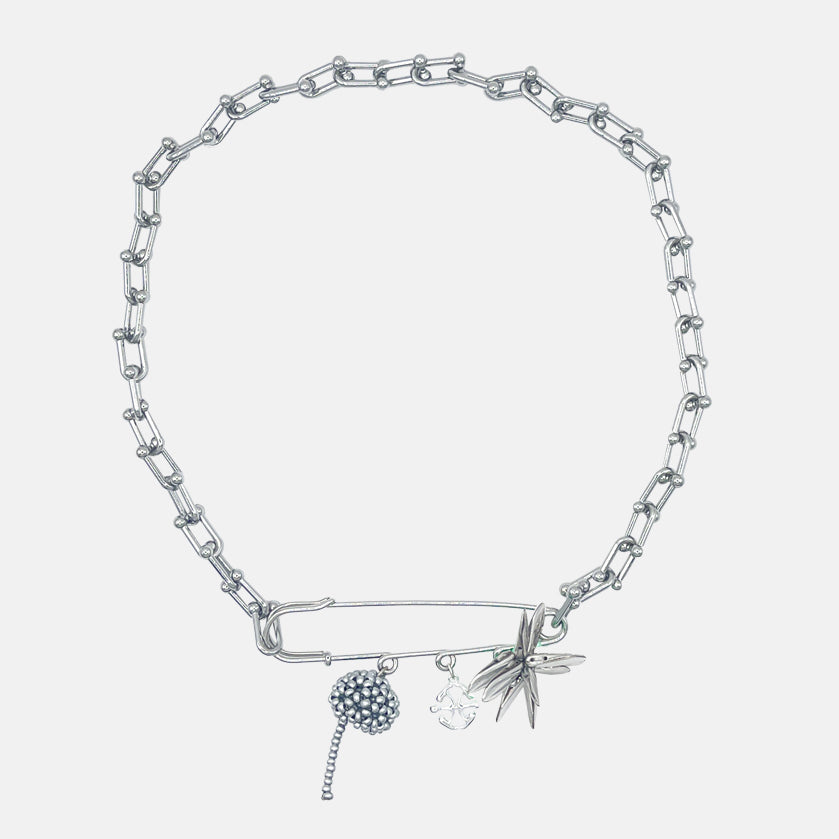 Silver necklace with beaded charms on a light gray background