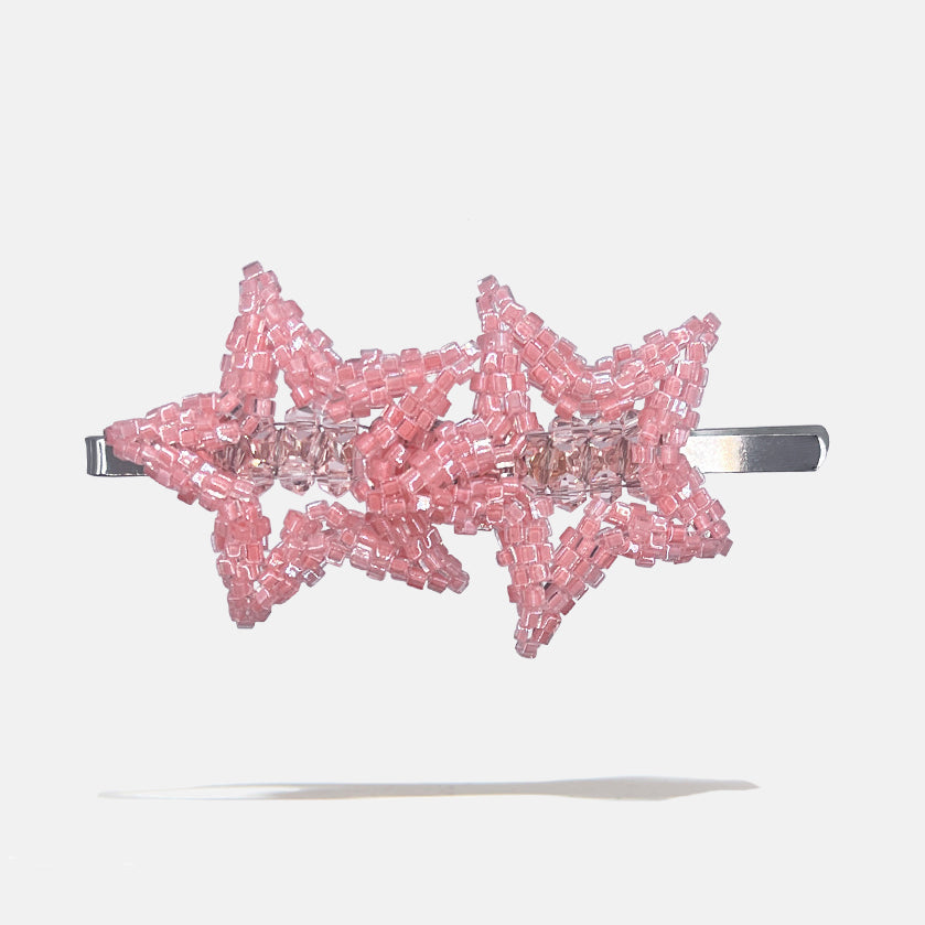 Pink beaded star-shaped hair clip on a white background