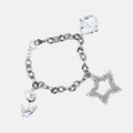 Silver bracelet with various charms on a light gray background