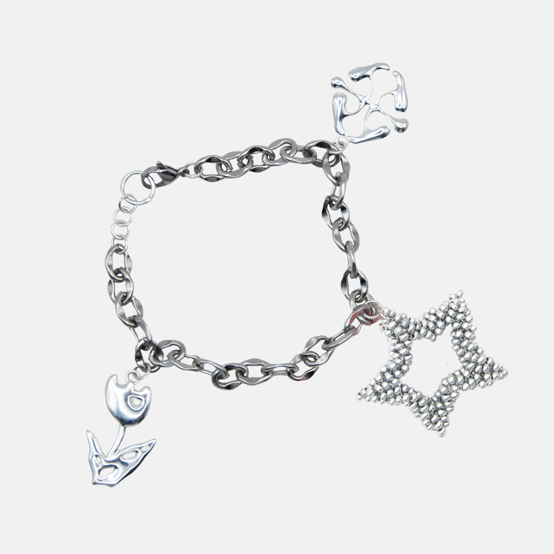 Silver bracelet with various charms on a light gray background