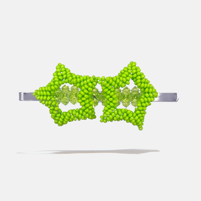 Green beaded star hair clip on a white background