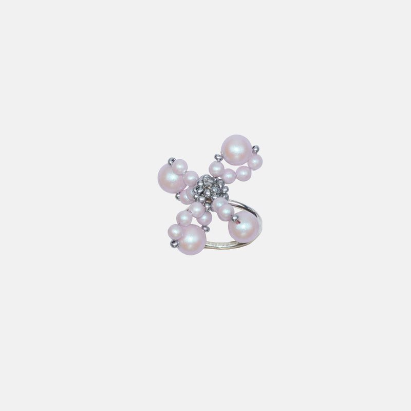 A silver and pink ring featuring a pink flower design with degenerative petals and a heart shape, made of crystal and glass.