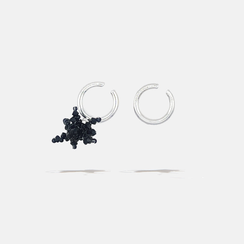 A brass silver fantasy set of earcuffs earrings with black beaded flower, product viewed from the side