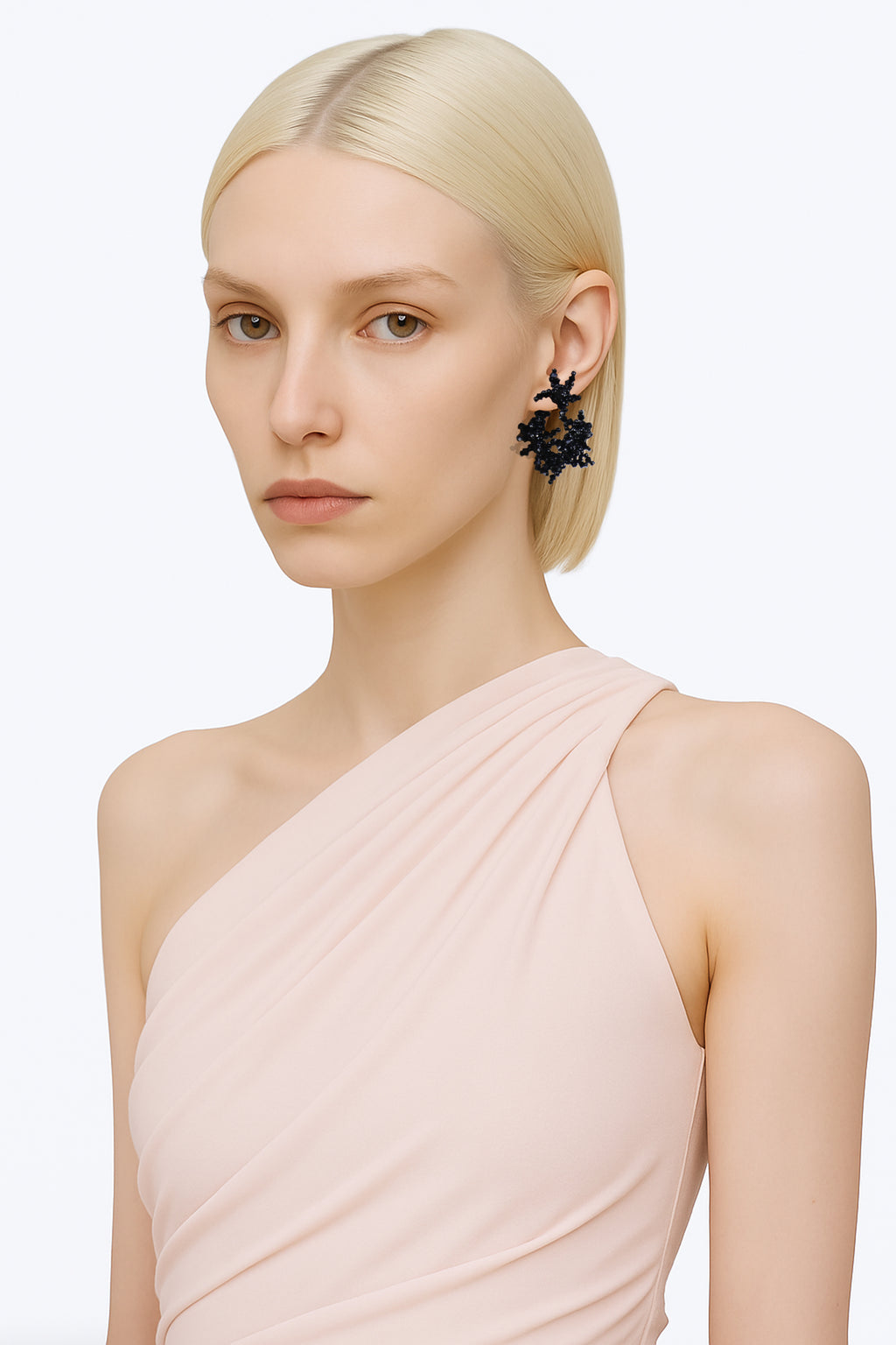 A brass black handcrafted beads hoop stud fantasy earring worn by an AI model with powder pink top and short polar blonde hair view from 3/4