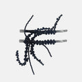 Black beaded hair pins on a white background