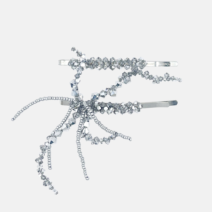 Silver set of hair clips with beaded decorative elements on a white background