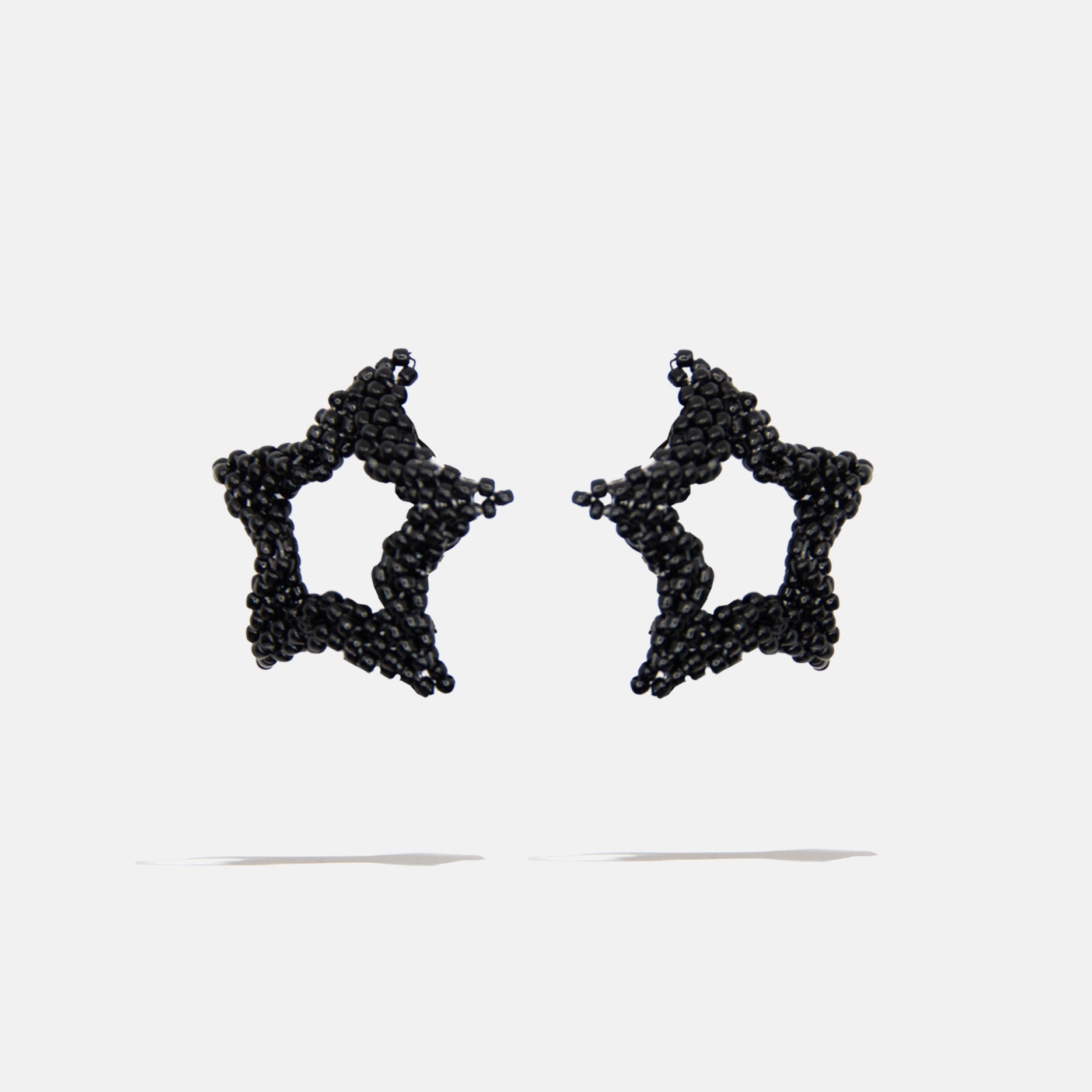 Black beaded star-shaped earrings on a white background